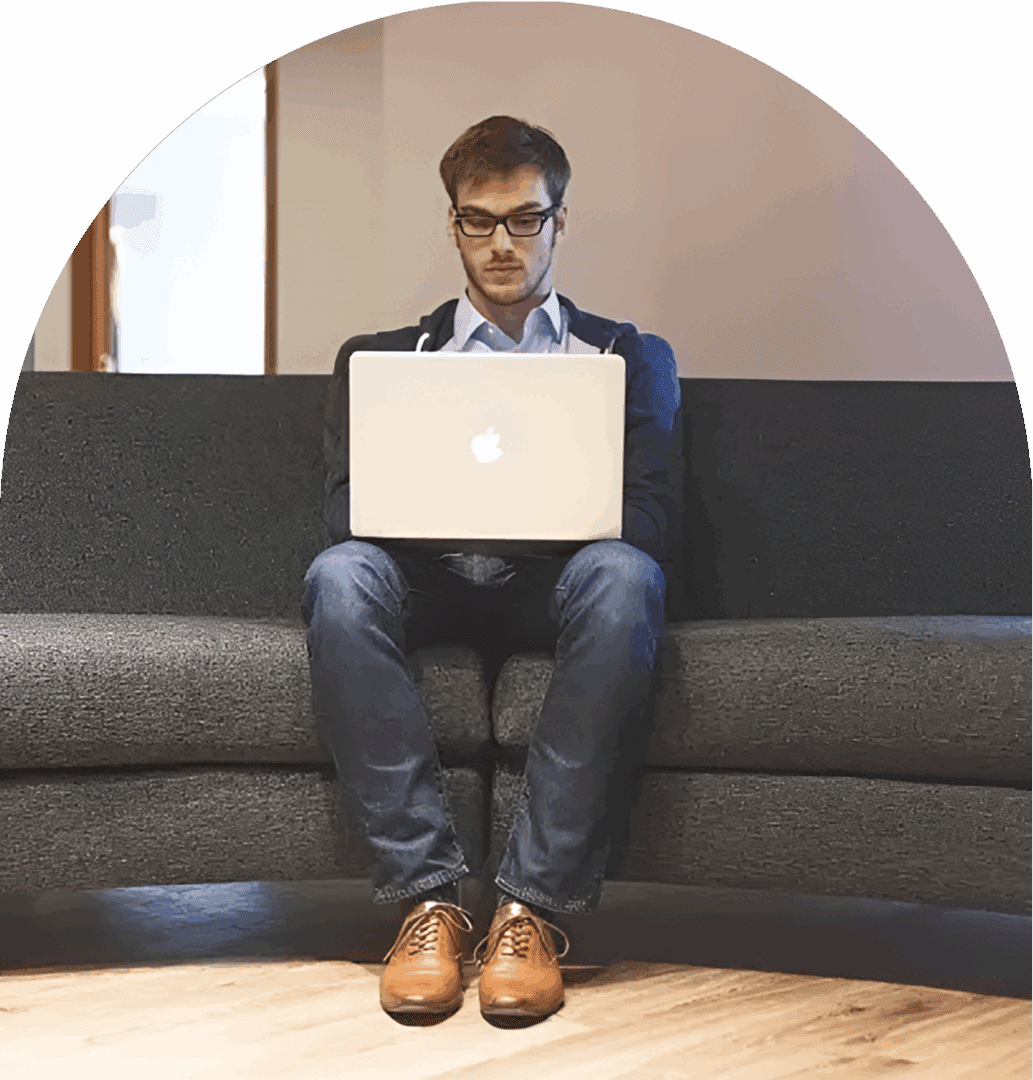 Person sitting with laptop indoors